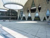 an empty building with large circular glass windows is shown with metal grates and metal grate