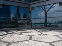 a circle made up of small circles on an outdoor area with a city reflection in the window