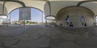 a photo of two big balls on the ground in front of some buildings, and a reflection in them