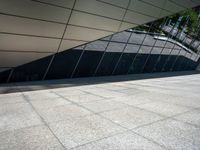 a building with silver and black architecture is seen in this photograph, which appears to be very modern