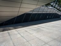 a building with silver and black architecture is seen in this photograph, which appears to be very modern