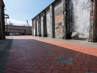 a skateboard is on a brick sidewalk with an empty area in front of it