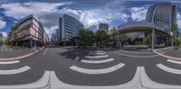 some buildings with curved streets and cars by it from the perspective of the fisheye lens