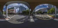 a fisheye lens of buildings and buildings in a city park with sky in the background