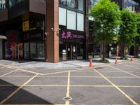 a corner store is shown with traffic cones in front of it on the street side