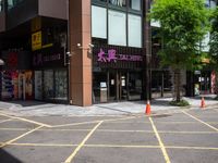 a corner store is shown with traffic cones in front of it on the street side