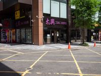 a corner store is shown with traffic cones in front of it on the street side