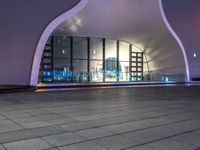 a black and white image of the inside of an architectural structure at night and the back ground is tiled