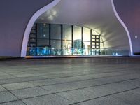 a black and white image of the inside of an architectural structure at night and the back ground is tiled