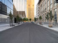 a street is pictured in the photo with tall buildings on either side and no one standing or walking across it