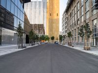 a street is pictured in the photo with tall buildings on either side and no one standing or walking across it