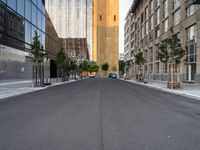 a street is pictured in the photo with tall buildings on either side and no one standing or walking across it