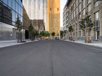 a street is pictured in the photo with tall buildings on either side and no one standing or walking across it