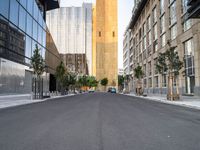 a street is pictured in the photo with tall buildings on either side and no one standing or walking across it