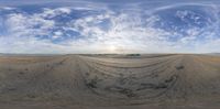 a fish eye photo of a vast plain and sky with some clouds at the top