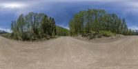 three dimensional view of a dirt road through a fisheye lens with trees in the background