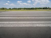 an airport runway with a stop sign sitting in front of it on a sunny day