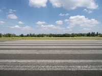 an airport runway with a stop sign sitting in front of it on a sunny day