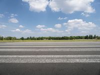 an airport runway with a stop sign sitting in front of it on a sunny day