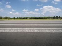 an airport runway with a stop sign sitting in front of it on a sunny day