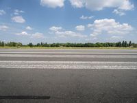 an airport runway with a stop sign sitting in front of it on a sunny day