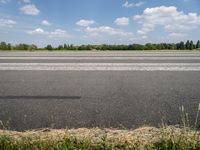 an airport runway with a stop sign sitting in front of it on a sunny day