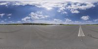 a panoramic view of a parking lot with one person standing in the road