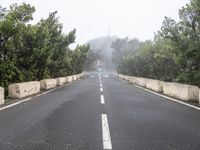 a road with no traffic on it, a stop sign and a curve road ahead