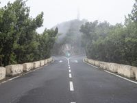 a road with no traffic on it, a stop sign and a curve road ahead