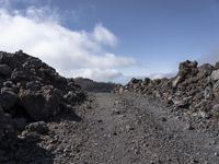 a view of the lava with clouds and trees behind it, in a mountainous area