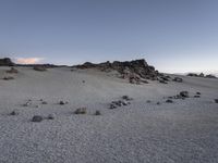 a picture of an empty desert with rocks and stones in it and the sky above