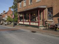 the old fashioned store is next to a street corner with antique items on display in front