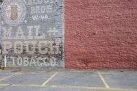 a wall sign is painted on the side of a building, with a red fire hydrant next to it