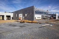 two construction workers are constructing the large building in the middle of nowhere from the inside