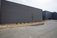 this building is constructed with grey siding and decorative rock edgings to create a beautiful wall