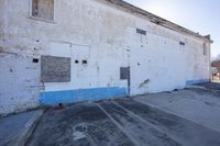 a picture of a wall outside an old building with peeling paint on them, along with blue and white paint