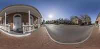 an image of a street taken from inside the fish eye lens of an outdoor area