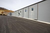 a row of storage units are near each other on the side of the building's driveway