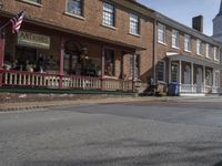 a town street is lined with old brick buildings and buildings that offer an attractive art gallery