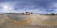 a circular shot of a construction site with dump trucks and other vehicles in the back