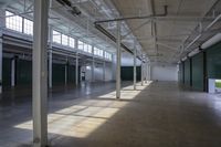 a empty indoor warehouse building with lots of light shining on the floor and floors and ceilings