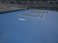 two tennis players are playing on the court at a tennis stadium that has blue and white colors