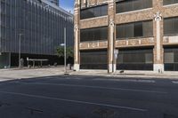 street with cars driving down it and a building behind it, and bicycle on the sidewalk