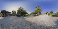 an image of two trucks parked in front of a building on a street, taken with a fish eye lens