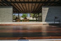 a person is sitting in a house sitting on the porch by himself or herself, outside and looking at the trees through the glass walls