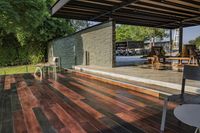 a deck in the backyard with table, chairs, and fire pit near by the pool