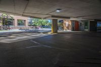 there is a parking space in this building where you can see some people and the light on