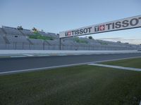 there is a big sign on the side of the track at the race track saying tissot