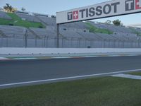 there is a big sign on the side of the track at the race track saying tissot