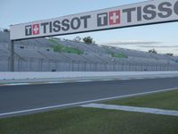 there is a big sign on the side of the track at the race track saying tissot